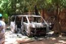 A photo taken on August 8, 2015 shows a burned vehicle in front of the Hotel Byblos in the central Malian town of Sevare, after gunmen stormed the hotel on August 7