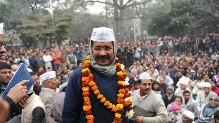 Arvind Kejriwal is greeted by supporters as he arrives at a public meeting in New Delhi on December 22, 2013