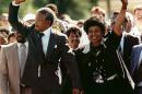 FILE - In this Feb. 11, 1990, file photo, Nelson Mandela and his wife, Winnie, raise clenched fists as they walk hand-in-hand upon his release from prison in Cape Town, South Africa. South Africa's president says, Thursday, Dec. 5, 2013, that Mandela has died. He was 95. (AP Photo/Greg English, File)