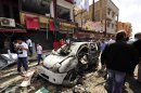 People gather at the scene of a car bomb explosion outside a hospital in Benghazi