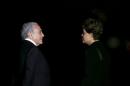 Brazil's Vice President Michel Temer talks with Brazil's President Dilma Rousseff as they await the arrival of German Chancellor Angela Merkel before a dinner at the Alvorada Palace in Brasilia