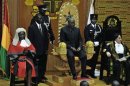 Ghana's Vice-President Mahama sits after taking the oath of office as head of state hours after the announcement of the death of Ghana's President Mills in the capital Accra
