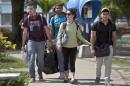 FILE - In this July 11, 2014 file photo, Cuban students exit Marta Abreu Central University in Santa Clara, Cuba. Since the U.S. eased travel restrictions in 2015, several colleges have struck agreements with Cuban schools to create exchange programs for students and faculty. More American colleges are planning study trips to Cuba. Both sides are exploring research collaborations. (AP Photo/Franklin Reyes, File)