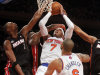 New York Knicks' Carmelo Anthony (7) shoots against, from left, Miami Heat's Chris Bosh (6), Dwyane Wade (3) and Rashard Lewis (9) during the first half of an NBA basketball game, Friday, Nov. 2, 2012, in New York. (AP Photo/Jason DeCrow)