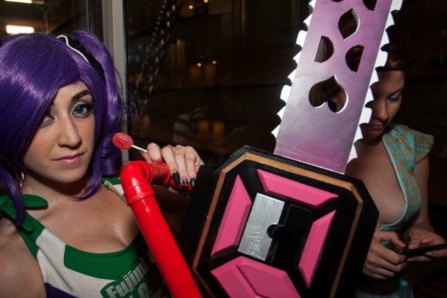 Forrest Gardner, of Atlanta, dressed as the video game character Lollipop Chainsaw, rides a crowded elevator during the annual Dragon Con sci-fi and fantasy convention on Saturday, Aug. 31, 2013, in Atlanta. (AP Photo/ Ron Harris)