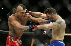 Chris Weidman and Vitor Belfort trade blows during their UFC 187 bout. (AP)