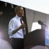During a brief rainstorm, U.S. President Obama speaks at a campaign rally at the Henry Maier Festival in Milwaukee