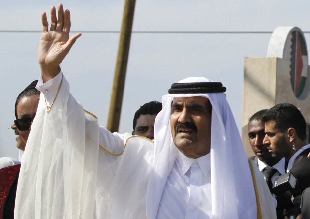 FILE- In this Tuesday, Oct. 23, 2012 file photo, Emir of Qatar Sheikh Hamad bin Khalifa al-Thani waves to the crowd as he and and Gaza's Hamas Prime Minister Ismail Haniyeh, not pictured, arrive for corner-stone laying ceremony of a Qatari funded rehabilitation center in Gaza City. (AP Photo/Hatem Moussa, Pool, File)