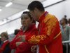 China's Guo Wenjun listens to her coach during the women's 10m Air Pistol qualification competition at the London 2012 Olympic Games