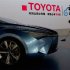 A worker cleans next to a Toyota NS4 plug-in hybrid concept car during the media preview of the 10th China International Automobile Exhibition in Guangzhou