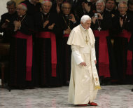 Pope Benedict XVI is applauded by prelates as he arrives for his weekly general audience in Hall Paul VI, at the Vatican, Wednesday, Dec. 19, 2012. (AP Photo/Alessandra Tarantino)