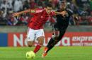 Al-Ahly's midfielder Ahmed Fathi (L) challenges Orlando Pirates' defender Thabo Matlaba during their African Champions League first leg final in Soweto on November 2, 2013
