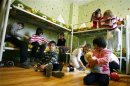Orphan children play in their bedroom at an orphanage in the southern Russian city of Rostov-on-Don
