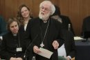 Dr Rowan Williams, centre, the outgoing Archbishop of Canterbury speaks during a meeting of the General Synod of the Church of England in central London, Tuesday, Nov. 20, 2012, - where a vote on whether to give final approval to legislation introducing the first women bishops will take place. The leader of the Church of England appealed for harmony among the faithful as it went into a vote Tuesday on whether to allow women to serve as bishops, a historic decision that comes after decades of debate. The push to muster a two-thirds majority among lay members of the General Synod is expected to be close, with many on both sides unsatisfied with a compromise proposal to accommodate individual parishes which spurn female bishops. (AP Photo/PA, Yui Mok, Pool)