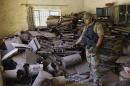 An Iraqi soldier inspects a recently discovered workshop belonging to Islamic State group militants used to manufacture explosives as Iraqi security forces advance their positions to retake the city from IS militants, on the southern outskirts of Fallujah, Iraq, Monday, June 13, 2016. (AP Photo/Anmar Khalil)