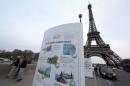 An information board about climate change is seen on a bridge near the Eiffel Tower ahead of the World Climate Conference 2015 (COP21), in Paris