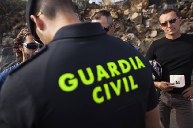 A Spanish Civil Guard authorizes fishermen and tourists to return to their boats after Tuesday's submarine volcano eruption in front of the town of La Restinga