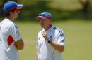 England Ashes Test cricket captain Alastair Cook (L) and coach Andy Flower (R) speak during a training session at a suburban cricket ground near Perth on October 29, 2013