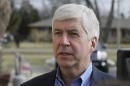 FILE-- In this Friday, Feb. 5, 2016 file photo, Michigan Gov. Rick Snyder is interviewed after visited a church that's distributing water and filters to its predominantly Latino parishioners in Flint, Mich. Snyder will propose spending $195 million more to address Flint's water crisis and another $165 million updating infrastructure across the state in response to lead contamination overwhelming the city. The plan will be detailed in the Republican governor's annual $54.9 billion budget presentation to the GOP-led Legislature on Wednesday, Feb. 10, 2016. (AP Photo/Carlos Osorio, File)