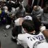 Baltimore Raven players pray in the dressing room around the AFC Championship Trophy after defeating the New England Patriots in the NFL AFC Championship football game in Foxborough