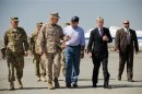 U.S. Defense Secretary Panetta speaks with U.S. Ambassador to Afghanistan Crocker and General Allen upon his arrival at Kabul International Airport