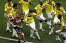 FILE - In this June 19, 2014, file photo, Colombia's James Rodriguez, center, dances with teammates in celebration after scoring during the group C World Cup soccer match between Colombia and Ivory Coast at the Estadio Nacional in Brasilia, Brazil. The euphoria in soccer-mad Colombia is deafening, and wonderfully contagious, ahead of Friday's do-or-die World Cup match against host Brazil. Not since Colombia drubbed Argentina 5-0 in a 1993 World Cup qualifier has the South American nation of 48 million been so enthralled by the beautiful game. (AP Photo/Themba Hadebe, File)