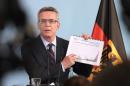 German interior minister Thomas de Maiziere attends a news conference in Berlin, Germany, Wednesday Aug. 19, 2015. Germany could see as many as 800,000 migrants in 2015, the country's interior minister said Wednesday, four times the number last year and 300,000 more than previously estimated. (Rainer Jensen/dpa via AP)