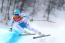 Austria's gold medalist Matthias Mayer makes a turn in the men's downhill at the Sochi 2014 Winter Olympics, Sunday, Feb. 9, 2014, in Krasnaya Polyana, Russia. (AP Photo/Alessandro Trovati)