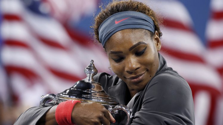 Serena Williams of the U.S. embraces her trophy after defeating Azarenka of Belarus in their women's singles final match at the U.S. Open tennis championships in New York
