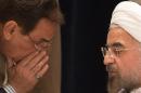 A member of Iran's delegation speaks to Iran's President Rouhani before a news conference in New York