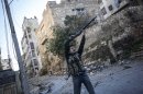 In this Wednesday, Nov. 14, 2012 photo, a Syrian rebel fighter aims at Syrian government forces during skirmishes in Aleppo, Syria. (AP Photo/Narciso Contreras)