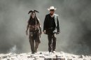 FILE - This undated file photo provided by Disney and Jerry Bruckheimer, Inc. shows Johnny Depp, left, as Tonto, and Armie Hammer as The Lone Ranger, in a scene from the film "The Lone Ranger." Domestic box office numbers so far on this long Fourth of July holiday weekend are suggesting the highly anticipated, $250 million Western extravaganza is in serious danger of becoming the train wreck of the summer movie season. The animated minions of family favorite 