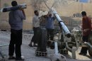 Free Syrian Army fighters prepare a mortar after what activists said were clashes between government forces and the Free Syrian Army in Damascus