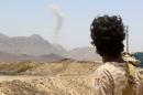A Yemeni fighter loyal to exiled President Abedrabbo Mansour Hadi looks at smoke rising in the distance in the Sirwah area, in Marib province, on April 10, 2016