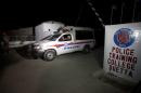 A police truck is seen at a gate to the Police Training Center after an attack on the center in Quetta