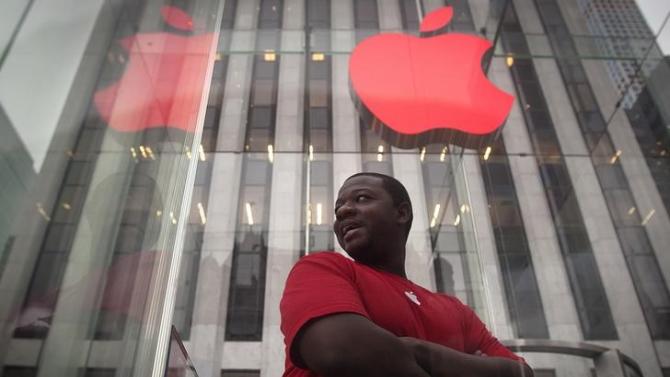 The Apple logo is illuminated in red at the Apple Store on 5th Avenue to mark World AIDS Day, in the Manhattan borough of New York