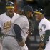 Oakland's Coco Crisp and first base coach Tye Waller celebrate Crisp's game winning RBI against Detroit in the 9th inning