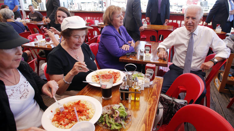 Vice President Joe Biden takes a seat with Rep. Carol Shea-Porter, D-NH, while stopping for lunch at the Old Ferry Landing restaurant in Portsmouth, N.H. Wednesday, Sept. 3, 2014. (AP Photo/Winslow Townson)