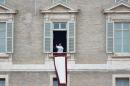 Pope Francis waves as he arrives to lead his first Angelus prayer from the window of the apartments in St Peter's Square in the Vatican on March 17, 2013