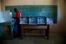 A voter casts his ballot at a polling station in the College Mixte des Cadres Evangeliques in Port-au-Prince on October 25, 2015