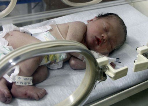 The baby who was stuck in a toilet pipe sleeps in an incubator at the Pujiang People's Hospital on May 29, 2013