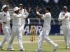 Pakistan's Umar Gul celebrates with teammates after taking the wicket of South Africa's Graeme Smith during the first day of their first test cricket match in Johannesburg