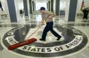 FILE – In this March 3, 2005, file photo a workman quickly slides a dust mop over the floor at the Central Intelligence Agency headquarters in Langley, Va., near Washington. Before Edward Snowden began leaking national security secrets, he twice cleared the hurdle of the federal government's background check system. The first was at the CIA, and the second was as a contract technician at the National Security Agency. (AP Photo/J. Scott Applewhite, File)