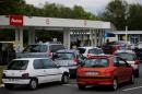 Cars wait to get gas at a petrol station in Saint-Sebastien-sur-Loire