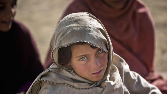 In this Monday, Jan. 19, 2015 photo, a Pakistani refugee schoolgirl attends class at Gulan camp, some 20 kilometers (12 miles) from the border in the restive Khost province, Afghanistan. For decades Afghans have fled into Pakistan to escape war and upheaval, but in recent months the tide has reversed, with some 60,000 Pakistanis - more than half of them children - taking refuge in the Gulan camp. (AP Photo/Massoud Hossaini)