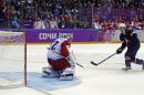 USA forward T.J. Oshie scores the winning goal against Russia goaltender Sergei Bobrovski in a shootout during overtime of a men's ice hockey game at the 2014 Winter Olympics, Saturday, Feb. 15, 2014, in Sochi, Russia. (AP Photo/Julio Cortez)