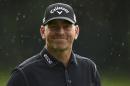 Denmark's Thomas Bjorn smiles in the rain on the 18 green during day one of the BMW PGA Championship at the Wentworth Club, Virginia Water England Thursday May 22, 2014. Bjorn shot a 10-under-par 62 in the first round.(AP PhotoAdam Davy/PA) UNITED KINGDOM OUT