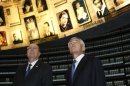 U.S. Defense Secretary Chuck Hagel, right, stands next to Israel's Defense Minister Moshe Yaalon as he looks at pictures of Jews killed in the Holocaust during a visit to the Hall of Names at Yad Vashem's Holocaust History Museum in Jerusalem on Sunday, April 21, 2013. (AP Photo/Baz Ratner, pool)