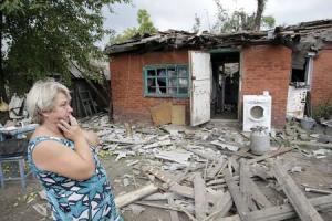 Woman reacts while standing outside her house, which&nbsp;&hellip;