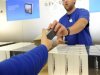 An Apple employee hands out an iPhone 5 at an Apple Store in San Francisco